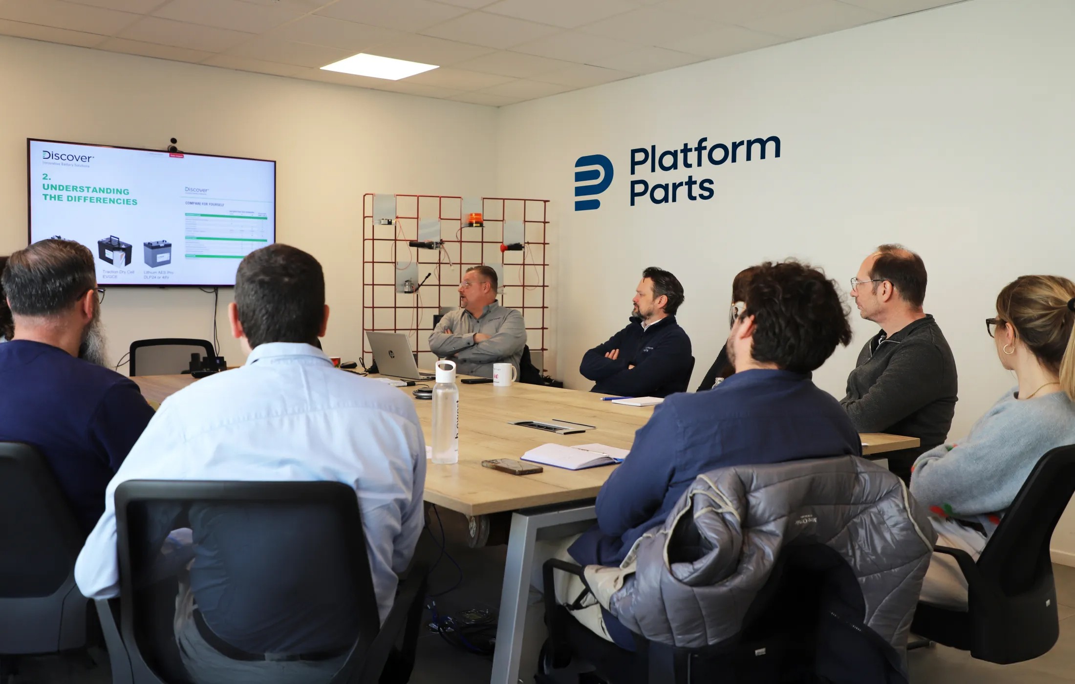 Platform Parts team attending a Discover battery training session in the meeting room.