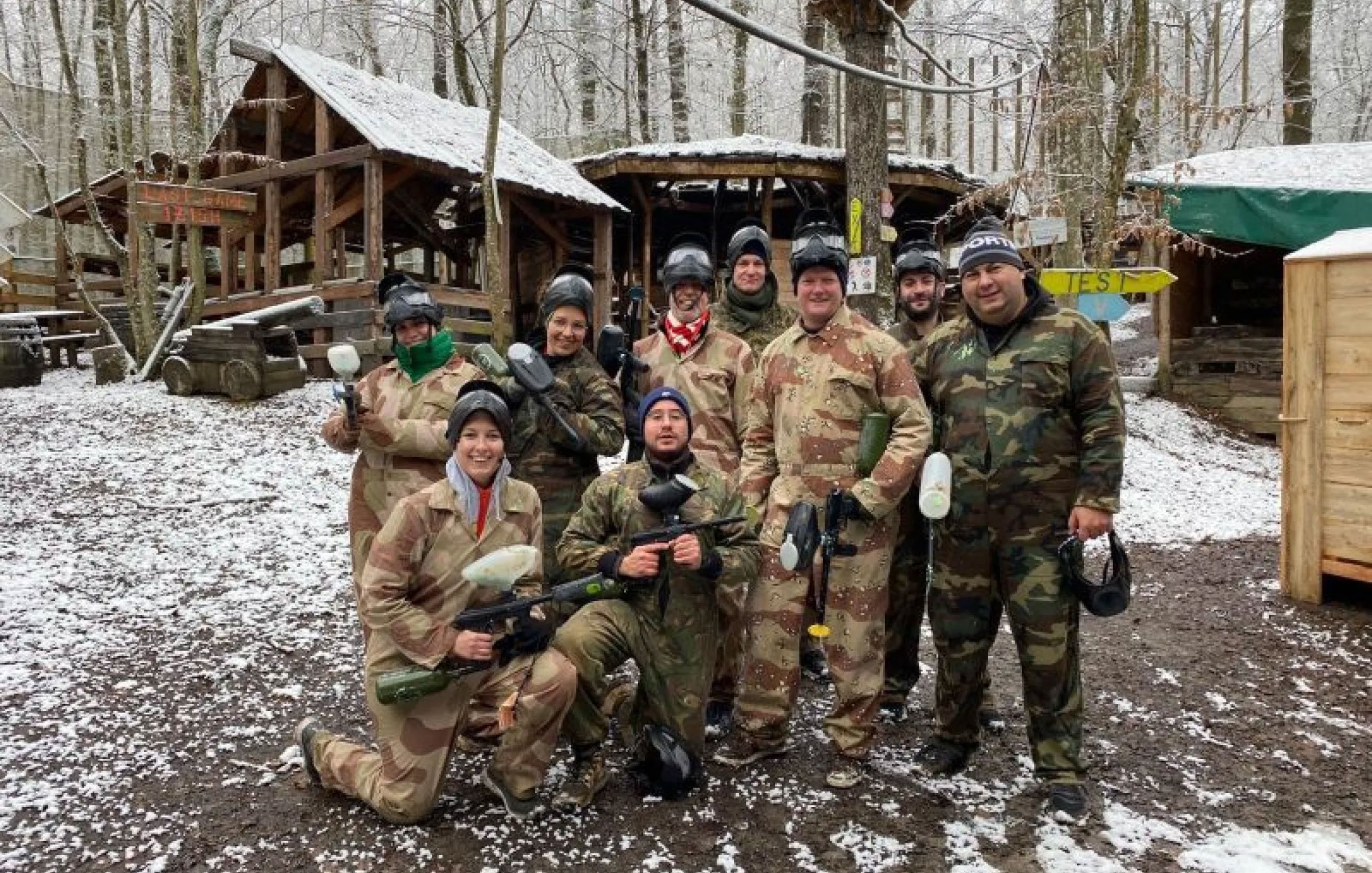 Platform Parts team members in paintball gear during a snowy outdoor teambuilding activity.